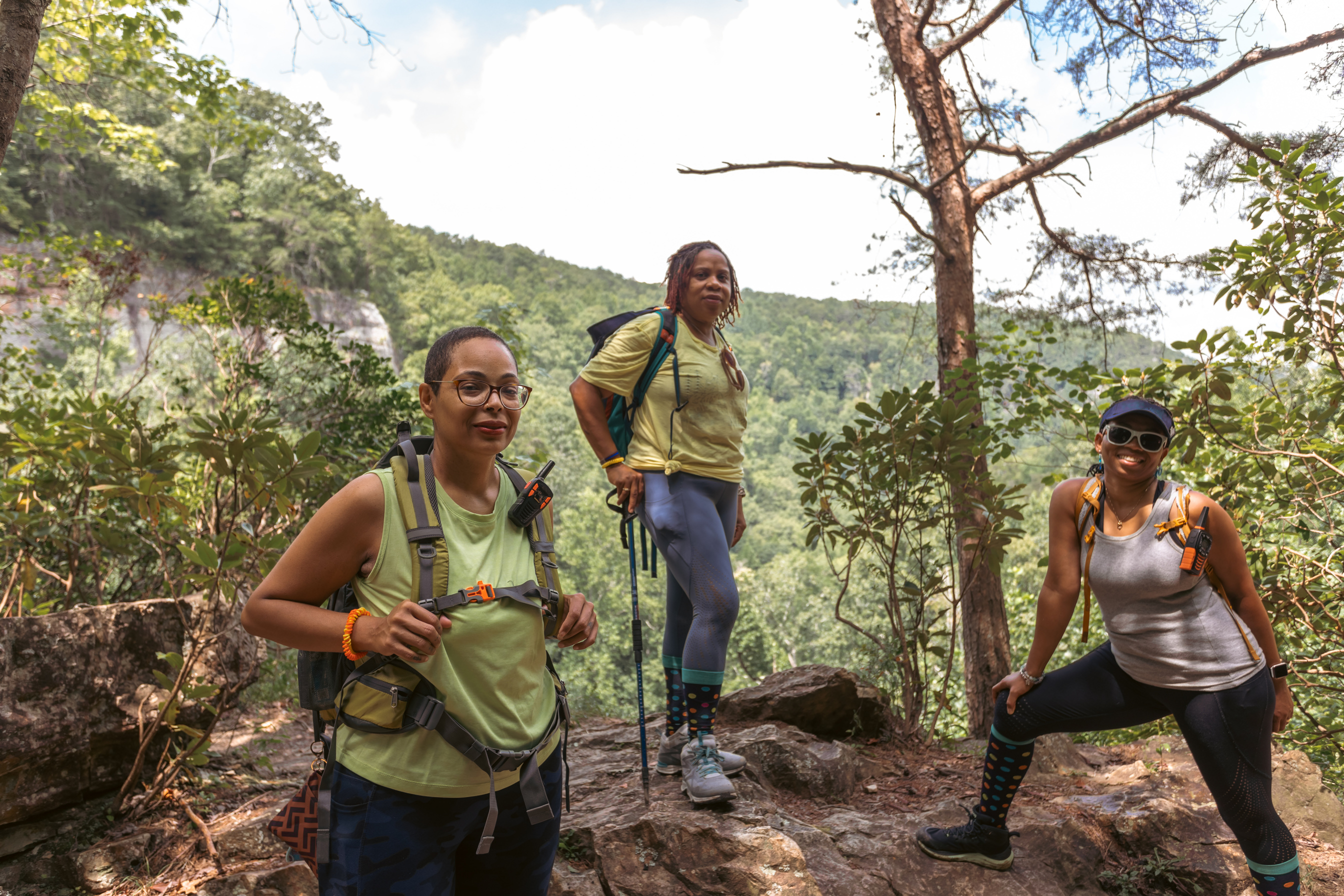 group of Black women hiking to top of mountain